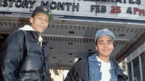 Getty Images Two young Technotronic rappers stand in front of a theatre marquee