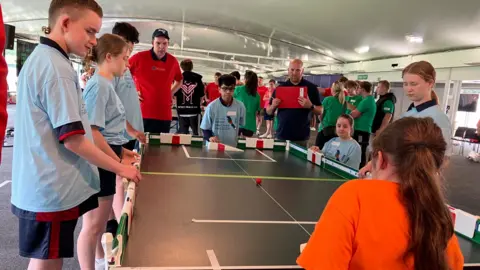 Sam Read/BBC Children playing table cricket