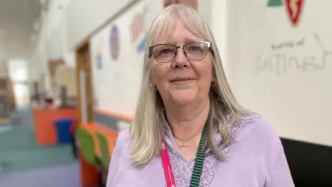 Make a Difference Cornwall winner Shelia Gill, who is wearing a pink top, has grey hair and glasses