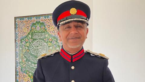 Rizwan Rahemtulla  wearing a blue and red Deputy Lord Lieutenant's uniform
