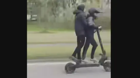 Two young people on an e-scooter