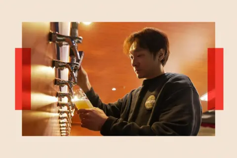 A worker brews a beer at Overtone Brewers