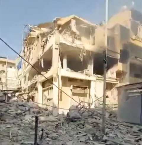 The damage to Mehdi and Zahraa's apartment, to the right of the image, was captured by someone filming following the strike.