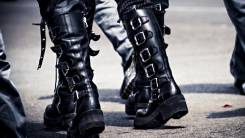 People in black goth-type boots walking down the street