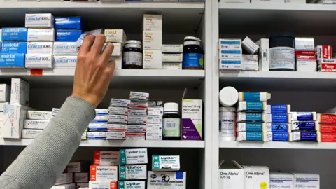 LDRS Pharmacist reaching for medicine