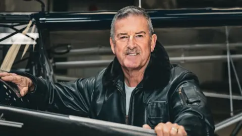 Andy Wyatt Former RAF pilot Andy Wyatt he has short grey hair and moustache and is wearing a black leather flying jacket