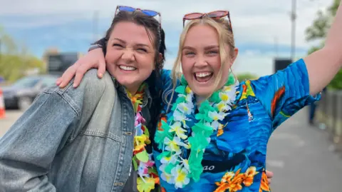 Lucy Finney and Cara Stepney are smiling in celebration.