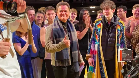 Matthew English Matthew English pictured with Donny Osmond filming The One Show. Matthew is wearing a scarf from Joseph and the Amazing Technicolor Dreamcoat.