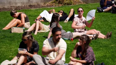 PA Media People sunbathing near St Paul
