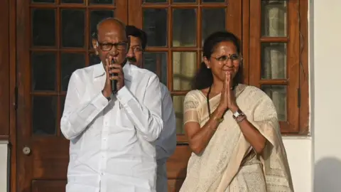 Getty Images Nationalist Congress Party (NCP) leaders, Sharad Pawar (L), and Supriya Sule (R), are gesturing before the Indian National Developmental Inclusive Alliance (INDIA) bloc meeting in New Delhi, India, on June 5, 2024. 