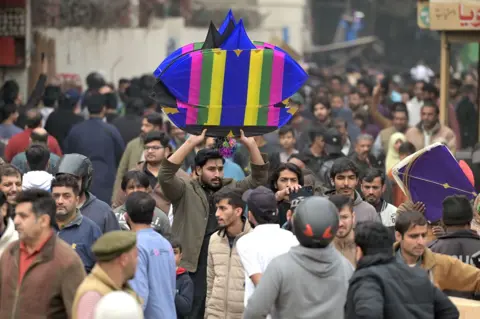 A HUSSAIN/EPA People rush to buy kites and stringers as the authorities officially start sales for the upcoming spring Basant festival in Lahore, Pakistan, 01 February 2026. 