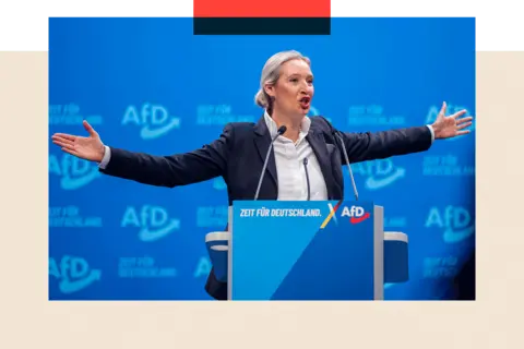 Getty Images Alice Weidel giving a speech with her arms stretched to both sides