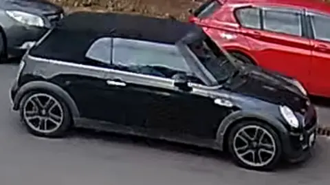 A black mini cooper.