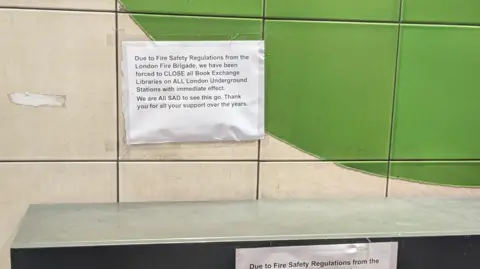 Sign reads "Due to fire safety regulations from the LFB, we have been forced to close all book exchange libraries on all LU stations with immediate effect.
We are all sad to see this go. Thank you for your support over the years."