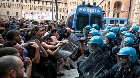 Protesters clash with riot police during a protest
