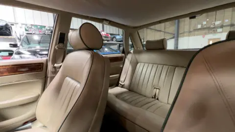 Cream leather seats in a green Jaguar XJ40.