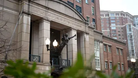 view of the front entrance to the Virginia Eastern District courthouse, with a statue of lady justice in front