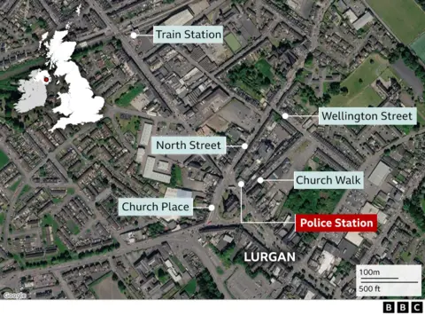 A satellite map view of Lurgan town centre. There are labels showing the roads affected by the security alert, including Church Place, North Street, Church Walk and Wellington Street. There is a red label showing the location of the police station and a label for the train station nearby.