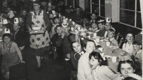 Newhaven Historical Society Children at tables for the factory's Christmas party in 1957.