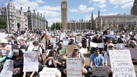 PA Media Supporters of Palestine Action take part in a mass action in Parliament Square, Westminster, central London on 9 August 2025.