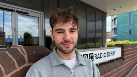 Mitchel Barwell, BBC Radio Derby producer, standing outside Bloomfield House in Derby.