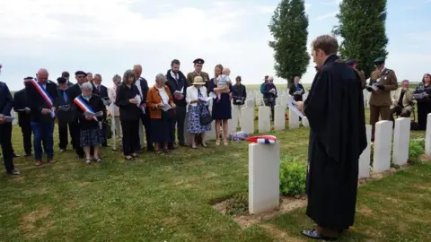 Colin Morris Photography Lt Osmond Wordsworth grave re-dedication ceremony. Civilians and soldiers are in attendance. Some are wearing the French flag.