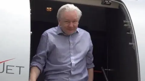 @WikiLeaks/PA Wire Assange leaves his jet in Bangkok, Thailand
