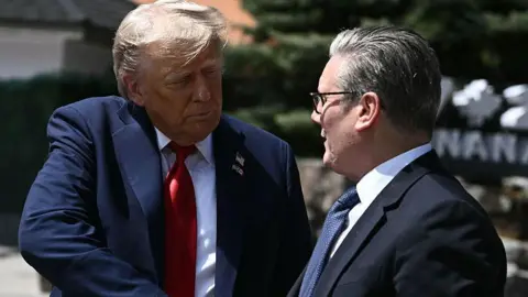 US President Donald Trump (L) shakes hands with British Prime Minister Keir Starmer as they speak to reporters after meeting during the Group of Seven (G7) Summit at the Pomeroy Kananaskis Mountain Lodge in Kananaskis, Alberta, Canada on June 16, 2025. 