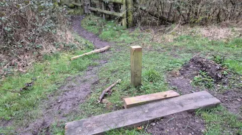 Carole Neesam A simple bench has been broken and is on the ground. 