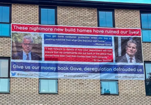 Agar grove with a banner outside with support expressed by housing minister Michael Gove and leader of the oppositionm, Keir Starker