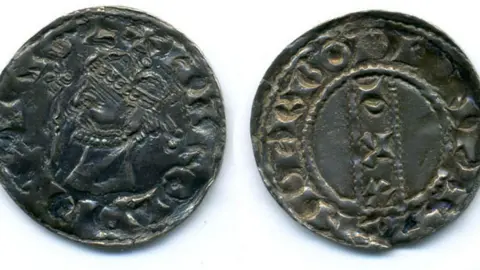 Winchester Council Collections/Hampshire Cultural Trust Two darkened Anglo-Saxon silver pennies sit on a white background.