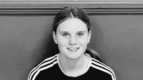 PA Media Black and white picture of a teenage girl with long hair in a pony tail