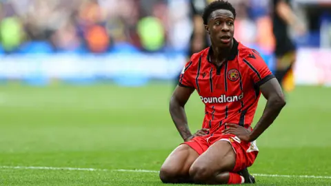 Walsall's Liam Gordon looks dejected kneeling down on the pitch after the final whistle at Wembley