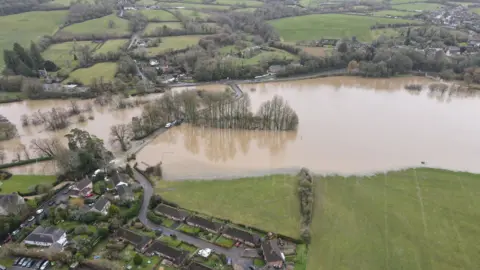 Adam Dodson Aerial view of the flooded river at Sturminster Newton and mill. The old stone bridge is mostly submerged.