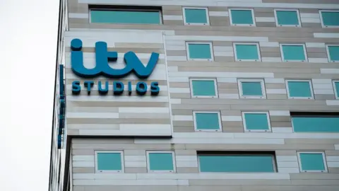 Getty Images The exterior of the ITV Studios office building in the Netherlands. The building itself is an uneven range of shades of light brown, with turquoise windows, and emblazoned with the company's logo in large turquoise letters.