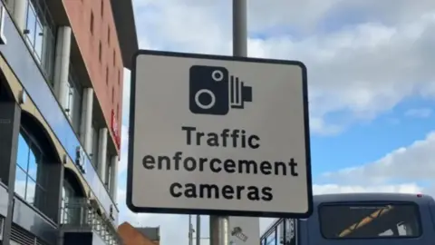 A road sign saying "traffic enforcement cameras"