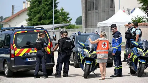 JEAN-CHRISTOPHE VERHAEGEN/AFP French gendarmes control the access to a secondary school after a 31-year-old teaching assistant was stabbed with a knife by a 15-year-old pupil during a bag search in Nogent, eastern France, on June 10, 2025