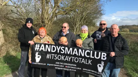 Federica Bedendo/BBC Players and supporters holding the Andy's Man Club banner