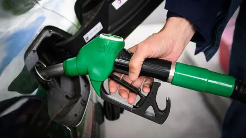 AFP via Getty Images A man fills in his car with petrol at a gas station in Saint-Etienne-de-Montluc, western France, on 15 April, 2026