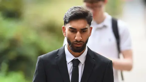 PA Media Mohammed Fahir Amaaz arrives at Liverpool Crown Court, where along with Muhammed Amaad they are charged in relation to an altercation with police officers at Manchester Airport's Terminal Two on July 23 2024.