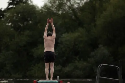 Getty Images A man dives into Hampstead ponds on Hampstead Heath on August 2, 2011 in London, United Kingdom