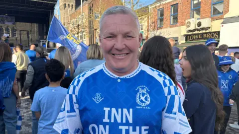 Trevor Boyd. He was white-ish hair and wearing a blue Dungannon Swifts jersey.