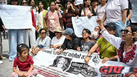 NurPhoto via Getty Images A child participates in a protest in Kathmandu, Nepal, on 22 August 2026, demanding justice for a three-year-old girl in Bara district, who was raped and killed.