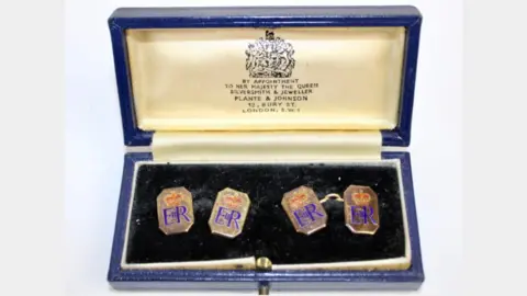 Hansons Auctioneers A pair of 9ct gold and enamel octagonal cufflinks with crowned ERII ciphers presented by Queen Elizabeth II to Squadron Leader Denis Lowery.