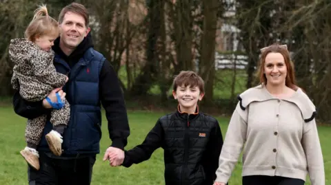 Chris Radburn/PA Wire Alfie Phillips with his mother Laura Ducker and her partner Scot Phillips and sister Matilda at their home near Northampton