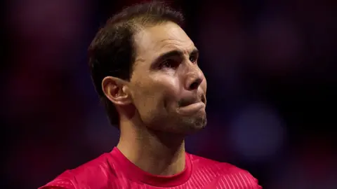 An emotional Rafael Nadal watches a tribute video after retiring from tennis