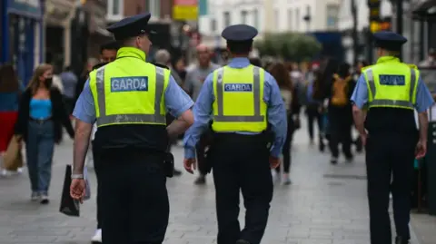 Getty Images/Nur Photo Three Garda officers patrolling Dublin city center in 2021