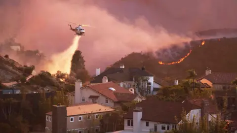 Fire crews work to suppress blaze as it nears homes