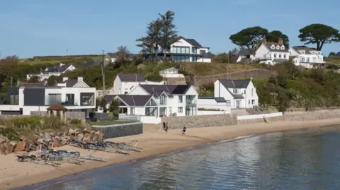 Getty Images Abersoch beach with beachside houses, trailers on the beach