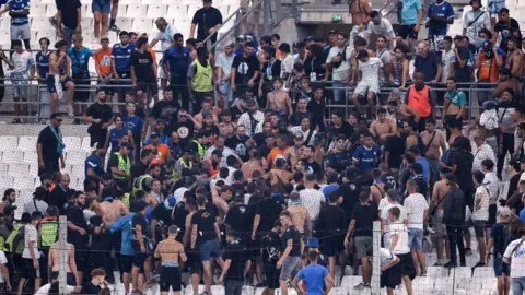 Getty Images Stewards break up scuffles amongst Marseille fans in August 2023 